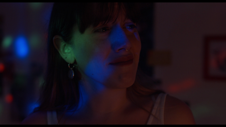 Close up of Anastasia in colourful light